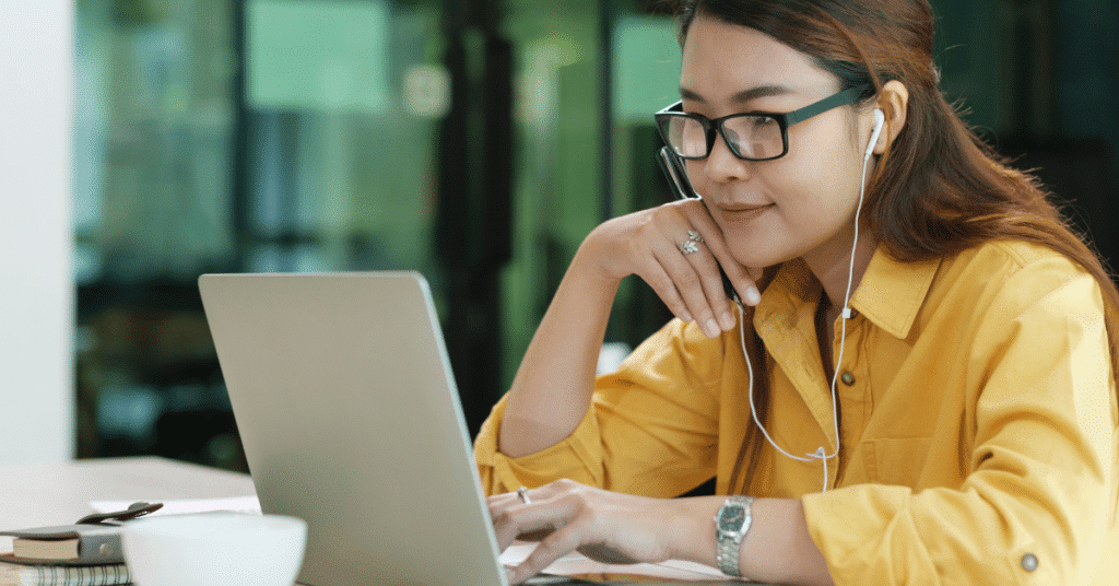 Blog header image showing a student with headphones focussed on their laptop