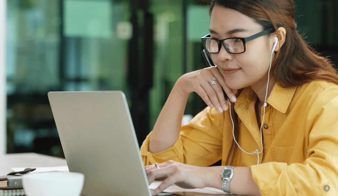 Blog header image showing a student with headphones focussed on their laptop